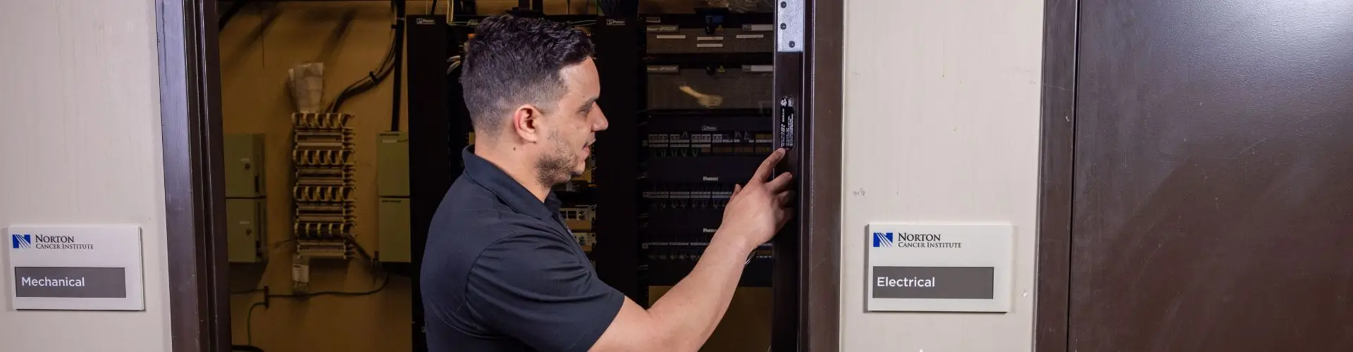 Health Choice Enterprises employee performing fire door inspection and maintenance.